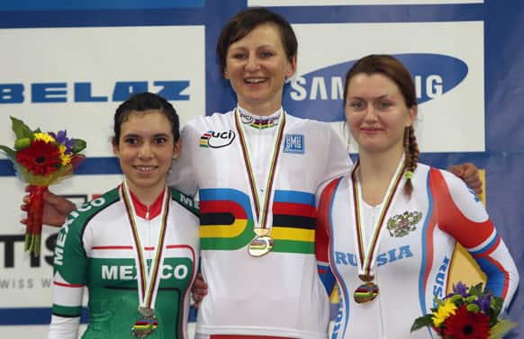 Gold medalist Poland`s Katarzyna Pawlowska, is flanked by silver winner Mexico`s Sofia Navarro Arreola, left, and bronze winner Russia`s Evgeniya Romanyuta during the awarding ceremony at the Women`s Scratch Race during the Track Cycling World Championships in Minsk, Belarus.