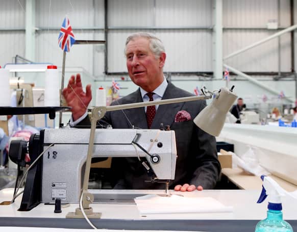 Britain`s Prince Charles tries his hand at shirt making during a tour of the Shirt Manufacturing Division of Turnbull & Asser in Gloucestershire, England, to commemorate the tenth anniversary of the factory.