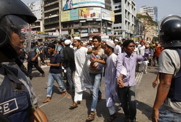 Bangladeshi Muslim activists shout slogans during a protest in Dhaka. Police fired rubber bullets and tear gas Friday to disperse thousands of rampaging protesters from Islamic parties, leaving two people killed and dozens injured, police and witnesses said.