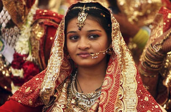 Bride takes part in a Muslim community mass marriage in Ahmedabad. A total of 151 Muslim couples tied the knot at the mass marriage.