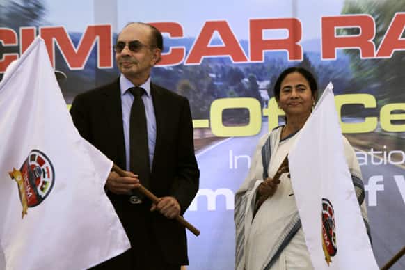 Trinamool Congress party (TMC) leader and chief minister of West Bengal state Mamata Banerjee, right, and Adi B. Godrej, Godrej Group Chairman, hold flags during the Bangladesh–China–India–Myanmar Forum for Regional Cooperation (BCIM) Car Rally 2013 in Kolkata.