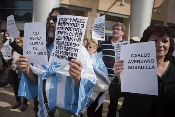 Demonstrators holding pictures and names of victims of the July 18, 1994, bombing in Argentina, that killed 85 people, protest outside the Embassy of Argentina in Herzliya, Israel.