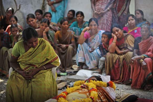 A woman, mourns by the body of her daughter Swapna Reddy, killed in Thursday’s explosion, at their house in Hyderabad.