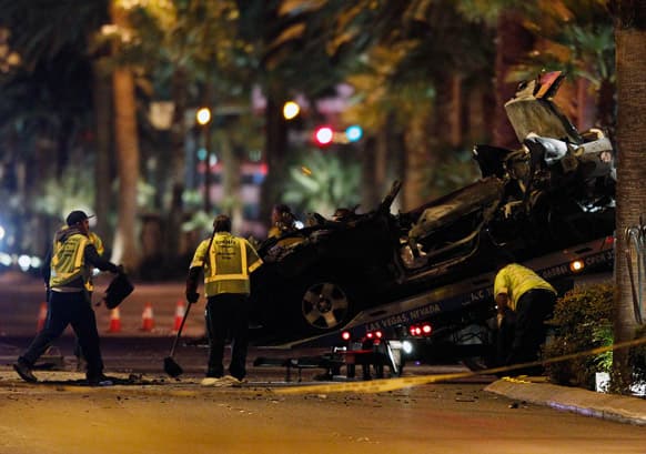 Tow truck drivers clean up and tow away cars involved in a drive-by shooting on Las Vegas Boulevard.