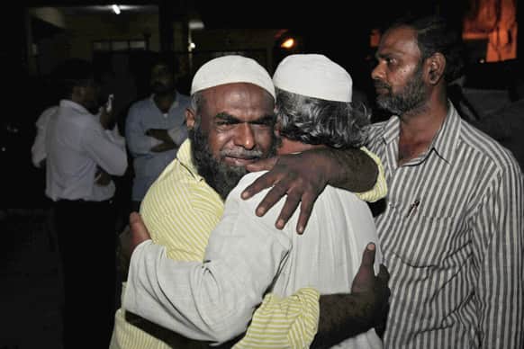 Azghar Ali, left, cries after identifying the body of his relative killed in a bomb blast, outside the mortuary of a Government hospital in Hyderabad.