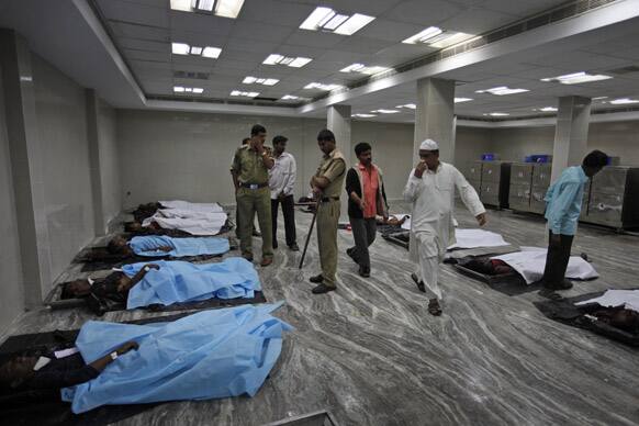 People identify the bodies of their relatives killed in a bomb blast, at the mortuary of a government hospital, in Hyderabad.