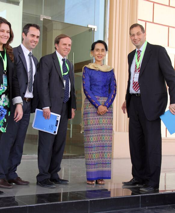 Myanmar opposition leader Aung San Suu Kyi pose for photos during her meeting at parliament building in Naypyitaw, Myanmar.