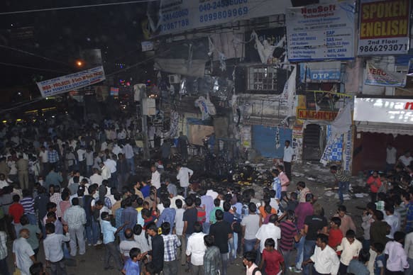 People gather on the scene after a bomb blast in Hyderabad. At least 11 people were killed and 50 injured Thursday in a pair of explosions in a crowded area of the southern Indian city of Hyderabad, officials said.