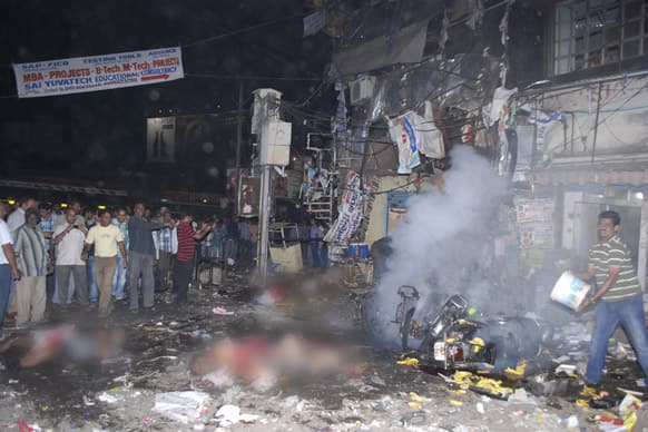 Bodies of victims lie on the ground after a bomb blast in Hyderabad. At least 11 people were killed and 50 injured Thursday in a pair of explosions in a crowded area of the Hyderabad.