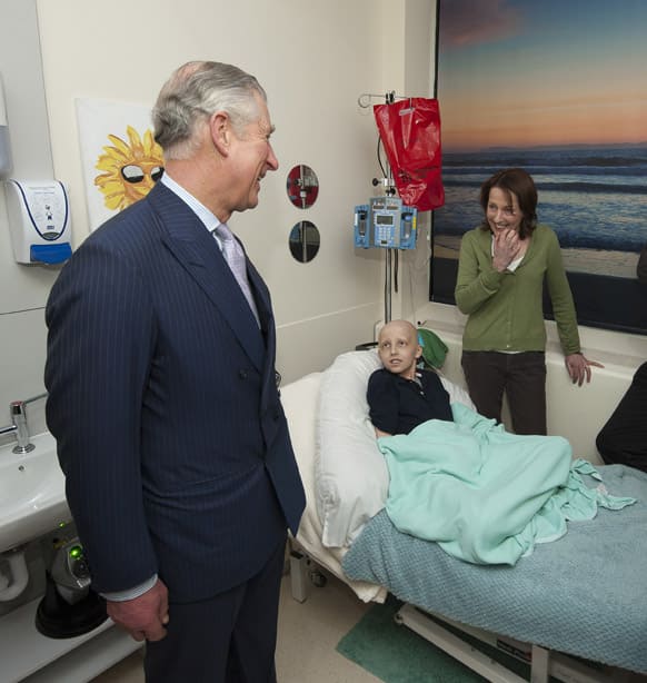 Britain`s Prince Charles, the Prince of Wales, speaks with 11-year-old brain tumour patient Marcus Henson and his mother Julie in the complimentary therapy massage room during a visit to staff and patients at Great Ormond Street Children`s hospital in London.