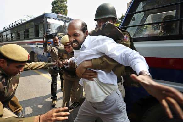A left-wing party activist is detained after several of them reached the Parliament to protest against Rajya Sabha Deputy Chairman P. J. Kurien, who has been charged in a 1996 rape case, on the first day of the budget session in New Delhi.