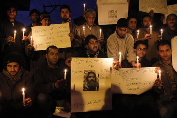 Kashmiris sit in a candle light protest in Srinagar, India, demanding the return of the remains of a Kashmiri man secretly executed and buried in the Indian capital.