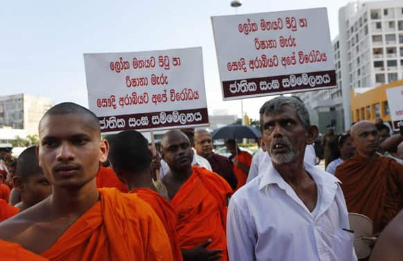 Sri Lankan Buddhist monks and their supporters march outside the president`s residence demanding authorities to stop sending Sri Lankan women as maids to the Middle East following the recent beheading of a Sri Lankan maid by Saudi Arabia, during a protest in Colombo, Sri Lanka.