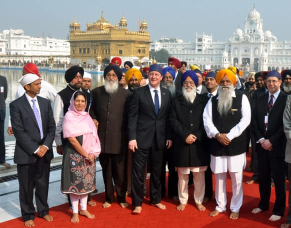 British Prime Minister David Cameron, center, visits the Golden Temple, Sikh’s holiest shrine, along with Chief Minister of Punjab state Parkash Singh Badal, center left wearing glasses, in Amritsar.