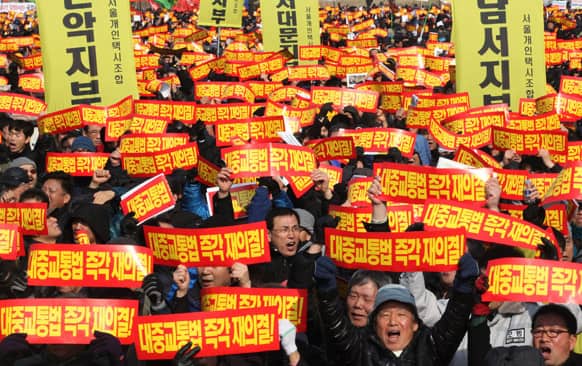 Taxi drivers shout slogans during a rally against government policy near the National Assembly in Seoul.
