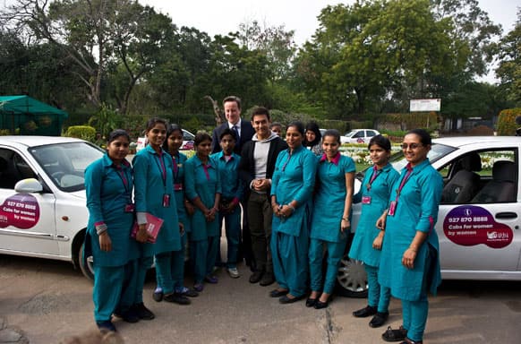 British Prime Minister David Cameron, center left, and Indian Bollywood actor Aamir Khan, center right, pose with Indian women cab drivers from Sakha cab services at the Janki Devi Memorial College in New Delhi.
