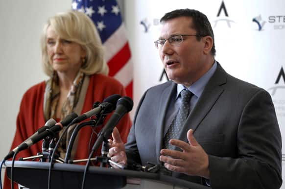 Arizona Gov. Jan Brewer, left, listens as Stealth Software CEO Gerard Warrens announces the Netherlands-based Stealth Software`s decision to locate their company`s USA headquarters to Arizona.