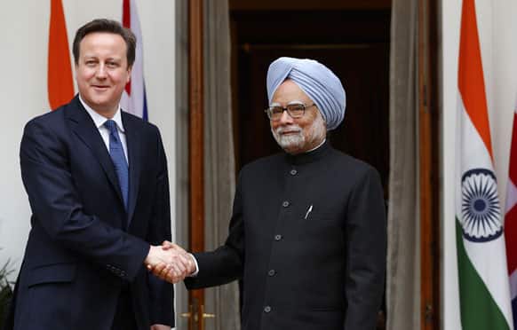 Manmohan Singh and British Prime Minister David Cameron shake hands before a meeting in New Delhi.
