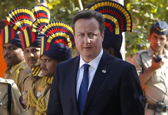 British Prime Minister David Cameron, center, arrives to pay tribute at the Police Memorial in Mumbai.