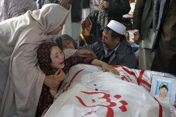 A Pakistani woman is comforted by other relatives while grieving over the body of her brother Mohammed Ali, who was killed in Saturday`s bombing, in Quetta, Pakistan.