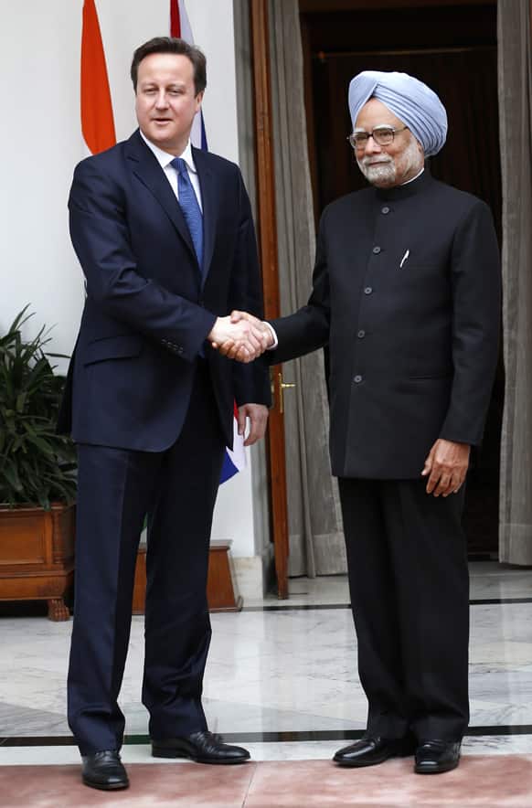 Prime Minister Manmohan Singh, right, and British Prime Minister David Cameron shake hands before a meeting in New Delhi.