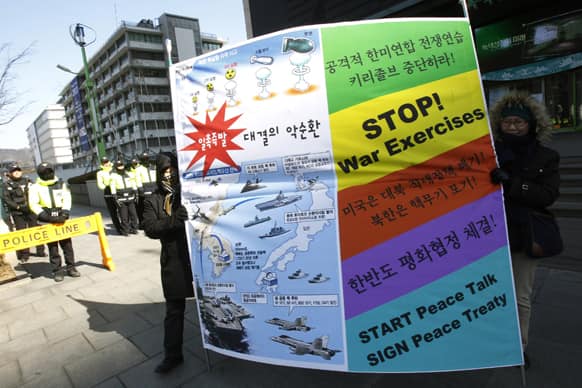 South Korean protesters carry a banner during a rally demanding a peaceful resolution to the North Korean nuclear crisis near the U.S. Embassy in Seoul.