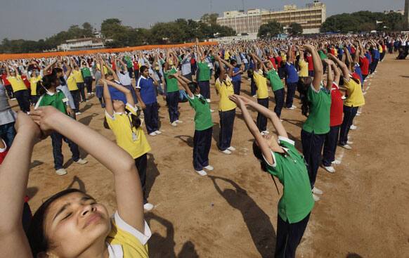 School children perform Surya Namaskar or Sun salutation during a function to mark 150th birth anniversary of Swami Vivekananda, in New Delhi.