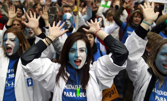 Protesters march as they shout slogans during a demonstration against regional government-imposed austerity plans to restructure and part-privatize the health care sector in Madrid, Spain.