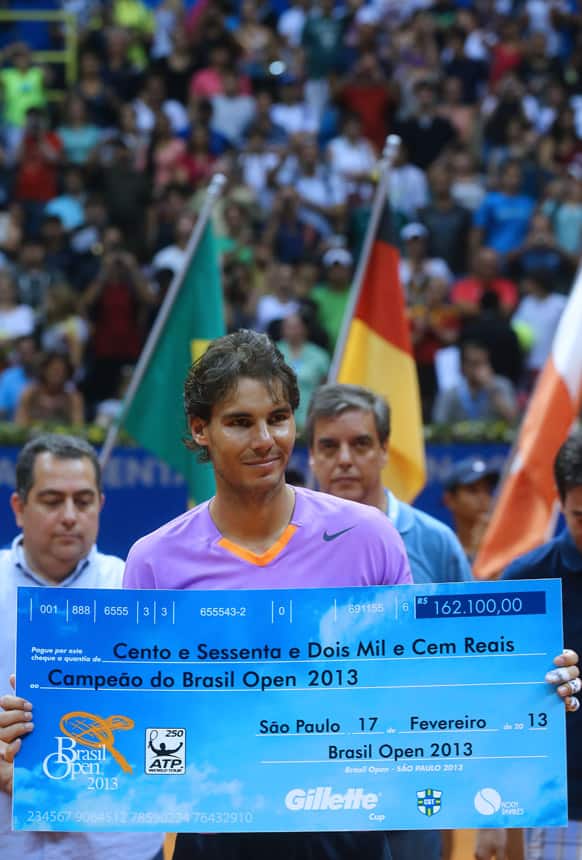 Spain`s Rafael Nadal holds a symbolic check during the Brazil Open ATP tennis tournament award ceremony in Sao Paulo, Brazil. Nadal defeated Argentina`s David Nalbandian 6-2, 6-3 in the final game.