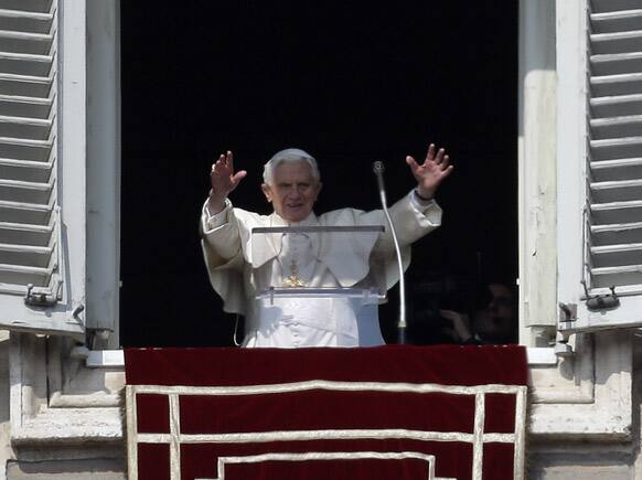 Pope Benedict XVI waves to the faithful during the Angelus noon prayer he celebrated from the window of his studio overlooking St. Peter`s square at the Vatican.