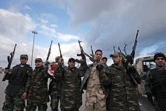 Libyan gunmen celebrate on the early morning of the second anniversary of the revolution that ousted Moammar Gadhafi, in Benghazi, Libya.