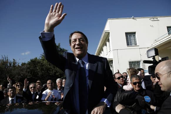 Right-wing opposition leader and presidential candidate Nicos Anastasiades waves to his supporters after voting in the Presidential election in southern port city of Limassol, Cyprus.