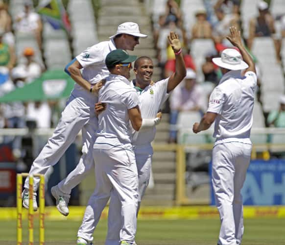 South African Vernon Philander, second right, reacts as they take the wicket of Pakistan`s Azhar Ali, unseen, on day four of the 2nd cricket test match in Cape Town, South Africa.