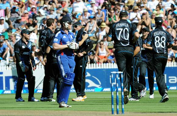 England`s Eion Morgan walks as New Zealand celebrate his dismissal for 1 during their first one day international cricket match at Seddon Park, in Hamilton, New Zealand.