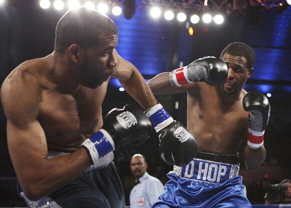 Charles Whittaker, left, of United States, gets knocked off balance by Demetrius Hopkins, of United States, in the first round of a junior middleweight boxing match in Atlantic City, N.J.