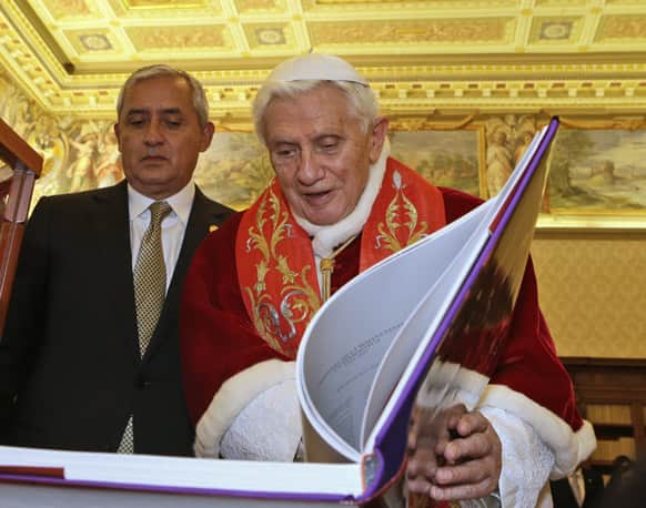 Pope Benedict XVI exchanges gifts with Guatemala`s President Otto Perez Molina, during a private audience at Vatican.