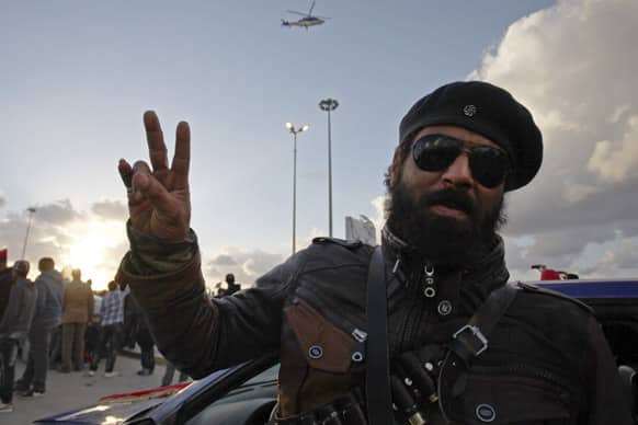 A Libyan rebel gives the victory sign during a celebration to commemorate the second anniversary of the revolution that ousted Moammar Gadhafi, in Benghazi, Libya.