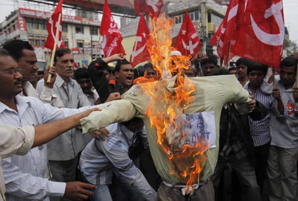 Activists of Communist Party of India (Marxist) burn an effigy representing the United Progressive Alliance (UPA) government during a protest against fuel price hike in Hyderabad.