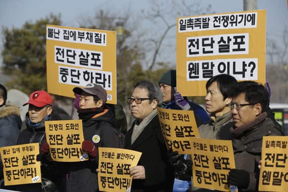 South Korean peace activists hold banners during a rally against anti-activists who send the leaflets at the Imjingak Pavilion near the border village of Panmunjom, in Paju, north of Seoul, South Korea.