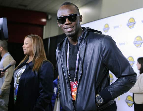 Olympic gold medalist Usain Bolt, right, and singer/actress Queen Latifah arrive at the NBA All-Star celebrity game, in Houston.