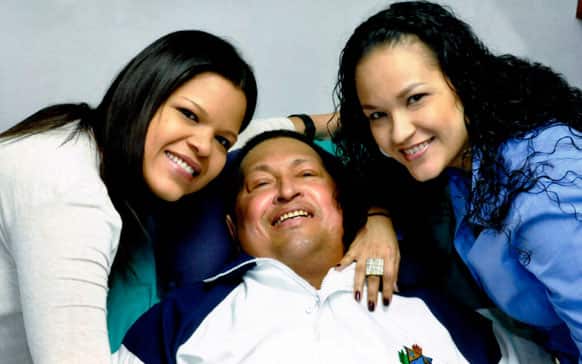 Venezuela`s President Hugo Chavez, center, poses for a photo with his daughters, Maria Gabriela, left, and Rosa Virginia at an unknown location in Havana, Cuba.