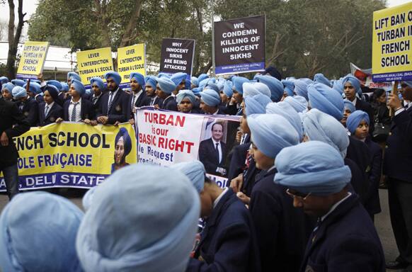 Indian Sikh school students carry placards during a protest against the ban on wearing turban in public schools in France, in New Delhi.