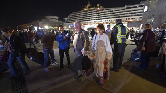 Passengers from the cruise ship Carnival Triumph are questioned by reporters after they disembarked in Mobile, Ala. The ship with more than 4,200 passengers and crew members has been idled for nearly a week in the Gulf of Mexico following an engine room fire.
