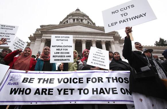 Somalian refugees (from left), Fowsiyo Abdekir, Kadra Abdi, Muna Abdirahman, Asha Nuur (Ethiopia) and Dunaye Hassan rally with Anisa Ali (far right) and members of the Refugee Women`s Alliance during the Refugee and Immigrant Legislative Day rally on the Capitol steps in Olympia, Wash.