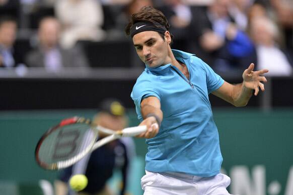 Roger Federer of Switzerland returns a shot against Thiemo De Bakker of The Netherlands at the ABN AMRO world tennis tournament at Ahoy Arena in Rotterdam, Netherlands.