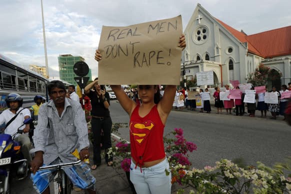 An activist holds a placard during a demonstration to mark