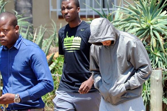 Olympic athlete Oscar Pistorius leaves the Boschkop police station, east of Pretoria, South Africa, en route to appear in court charged with murder.