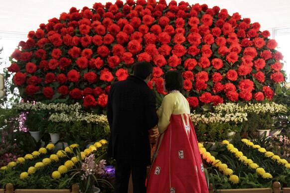 A guide, right, talks to a visitor at the opening of the 17th Kimjongilia Festival at the Kimilsungia-Kimjongilia Exhibition Hall, in Pyongyang, North Korea.