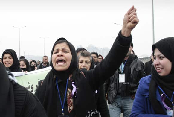 An Afghan woman shouts during a march calling for the end of violence against women, in Kabul.