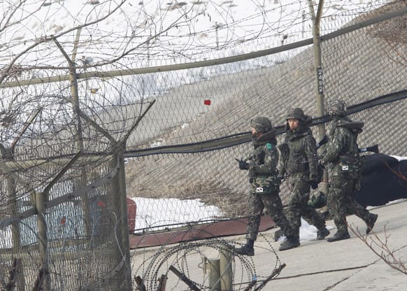 South Korean army soldiers patrol along the barbed-wire fence under a heightened alert put in place in the wake of North Korea`s nuclear test near the demilitarized zone of Panmunjom, in Paju, South Korea.